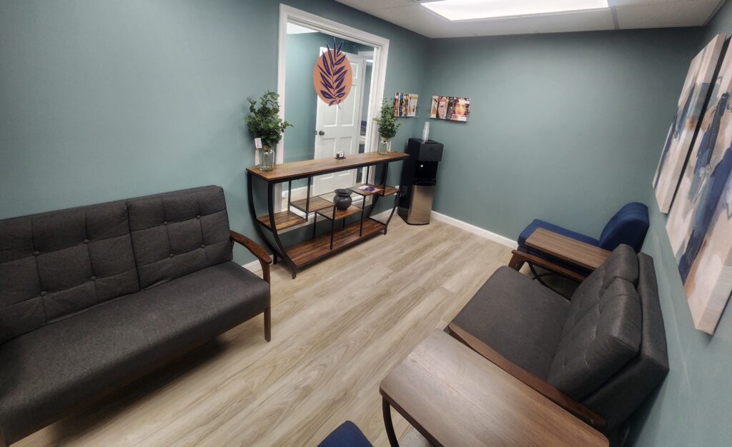 Sanative Counseling and Wellness Center Suite 103 Waiting Room 2 Photo of waiting room at Sanative Counseling and Wellness Center Suite 103, room includes a couch, two chairs and two side tables
