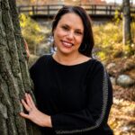 Photo of Nicole Clark, MA, standing against tree outside