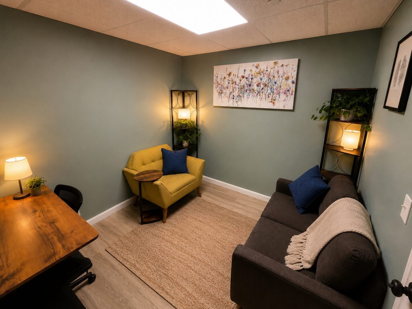 Photo of Sanative Counseling and Wellness Center Suite 103 Office 6 featuring two bookshelves, couch, chair, and desk